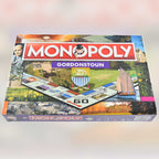 Monopoly board game box with 'Gordonstoun' edition on a blured background